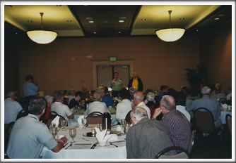 Bob Thompson conducting Banquet Program attended by Kriegies and their families